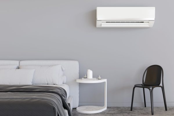 Modern air conditioner hanging on the wall in room. Cooling product for hot climate in summer. Machine which keeps the air in a building cool and dry. Modern interior with air-conditioning. 3D render